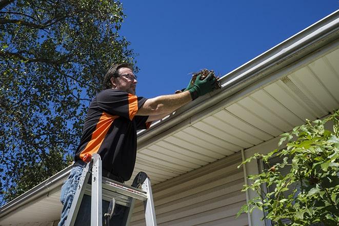 home maintenance worker repairing a leaky gutter in Berwyn Heights